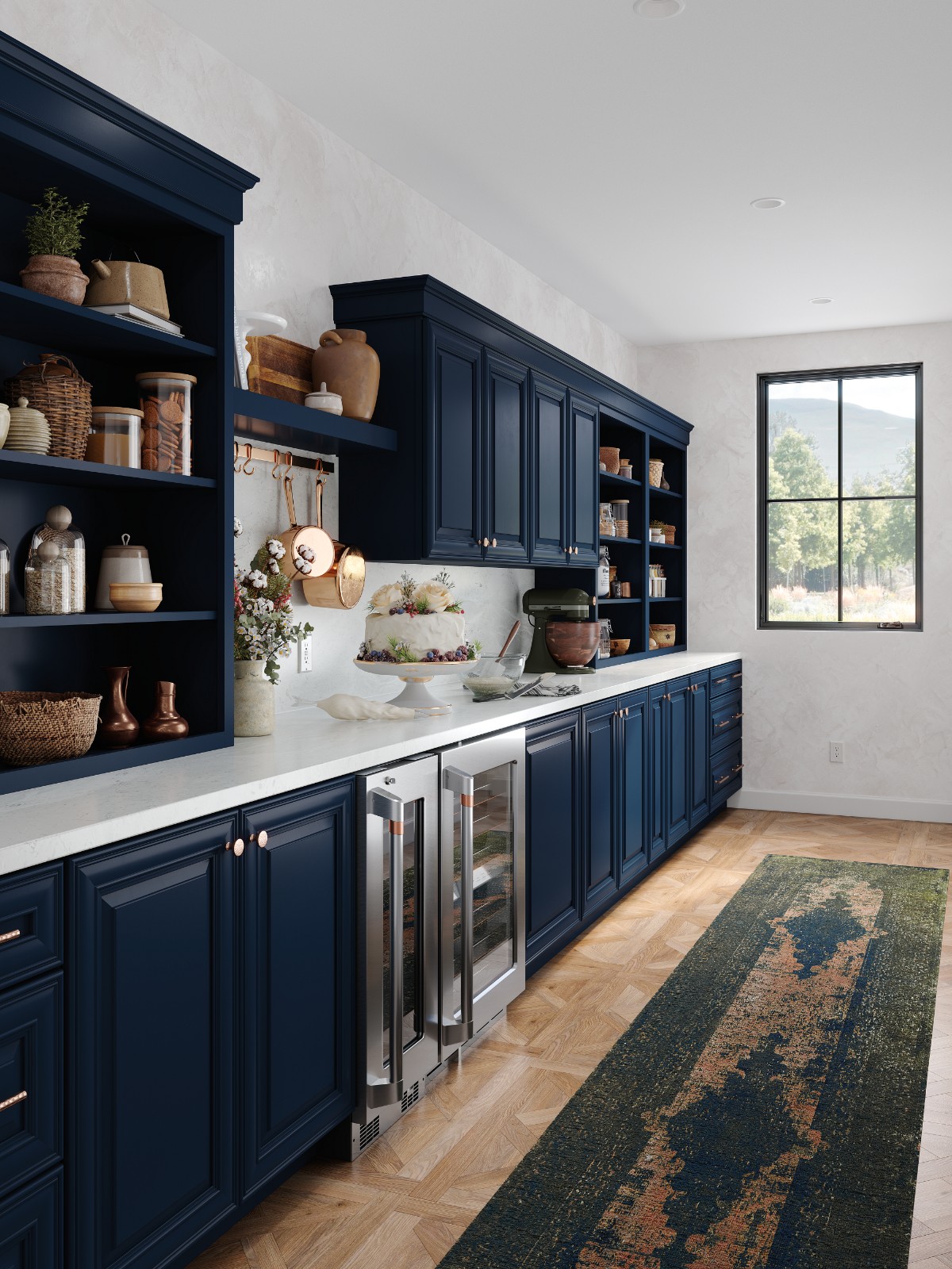 Blue kitchen cabinets and white countertops with a cake on display for cabinet design consultation.