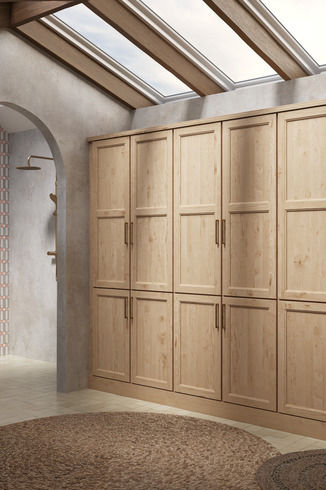 Wall-to-wall light wood bathroom cabinets near me, a skylight, and an arched shower entrance.