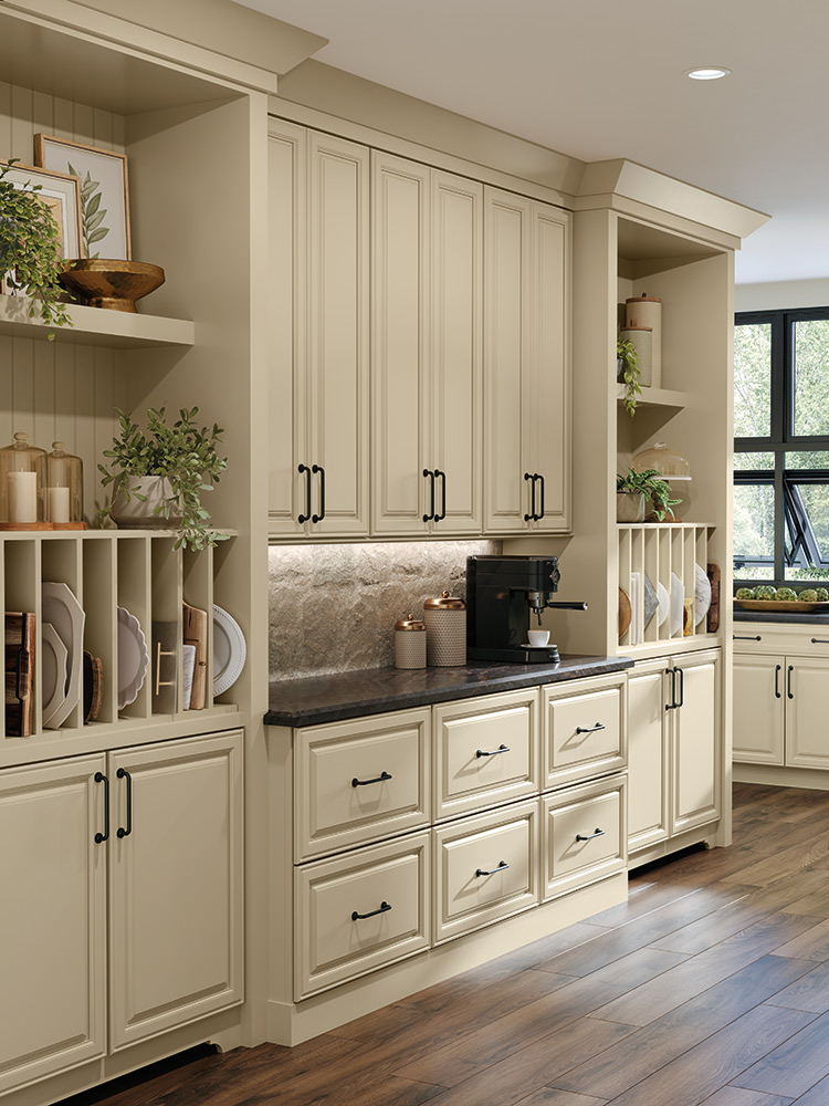 Cream-colored kitchen cabinets from top brands with black hardware and an integrated coffee station.