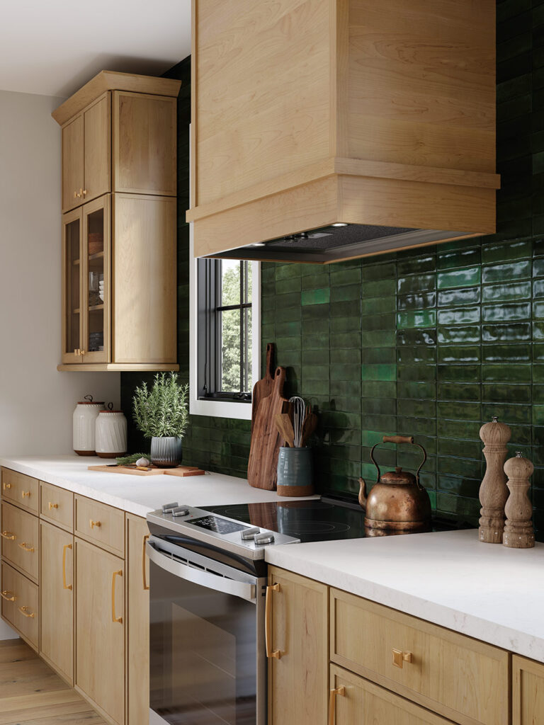 Kitchen with light wood cabinets, dark green subway tile backsplash, and a range stove.