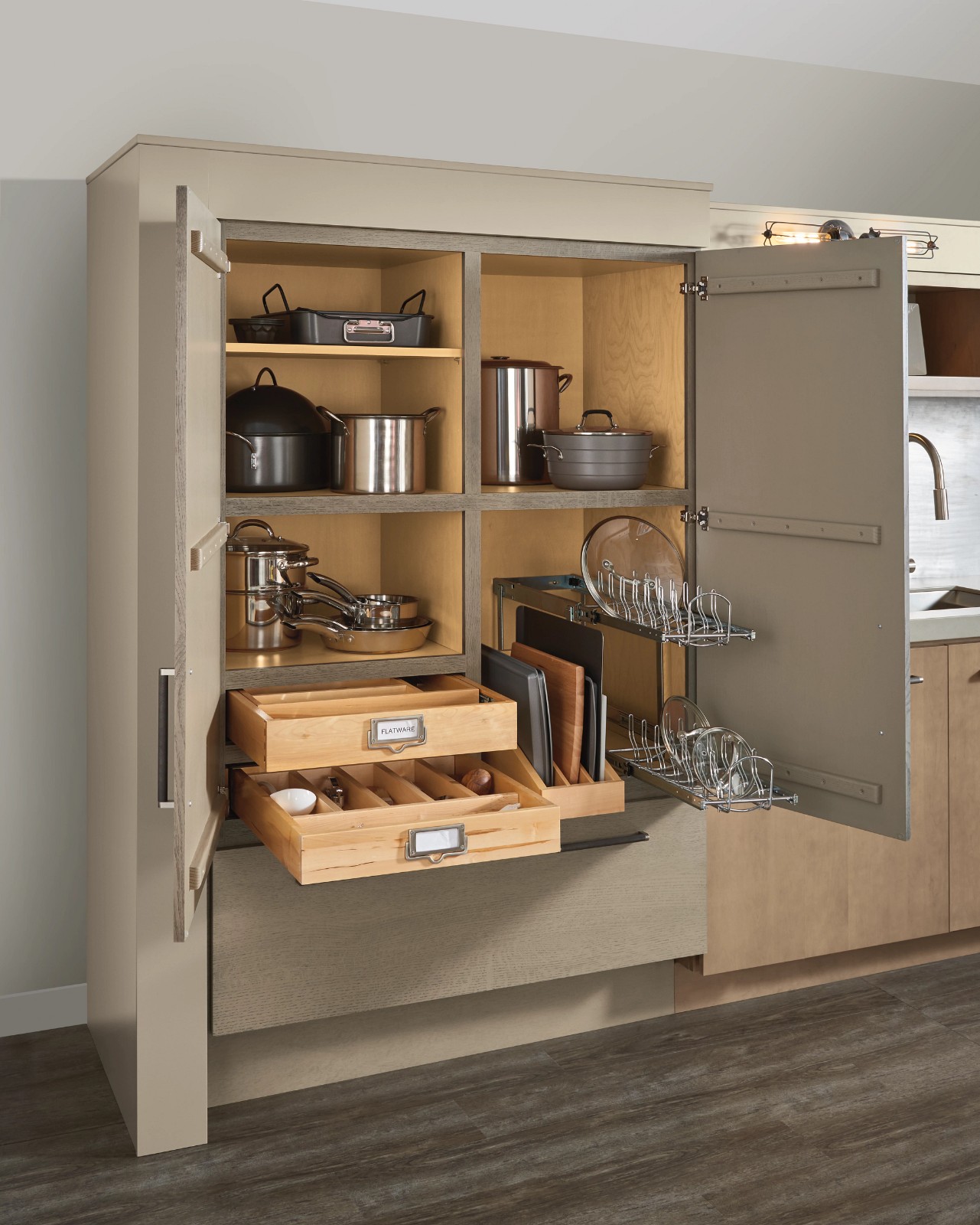 Open kitchen pantry cabinet featuring top cabinet brands with pull-out drawers and cookware storage.