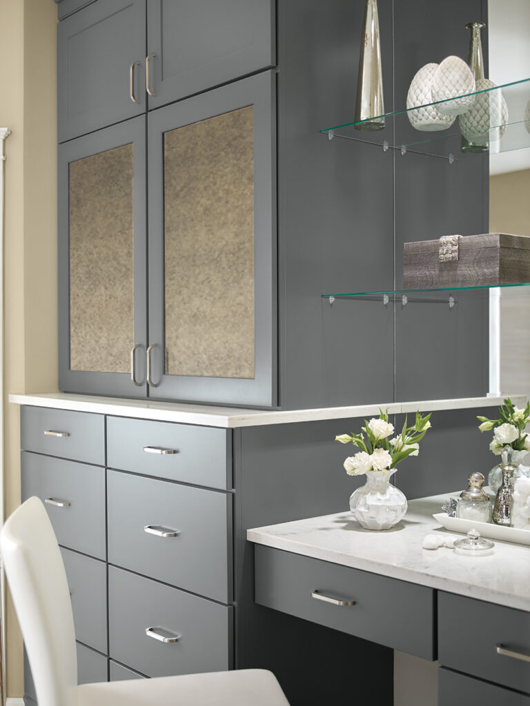 Grey cabinetry with glass shelving and a marble-topped vanity, ideal for bathroom cabinets near me.