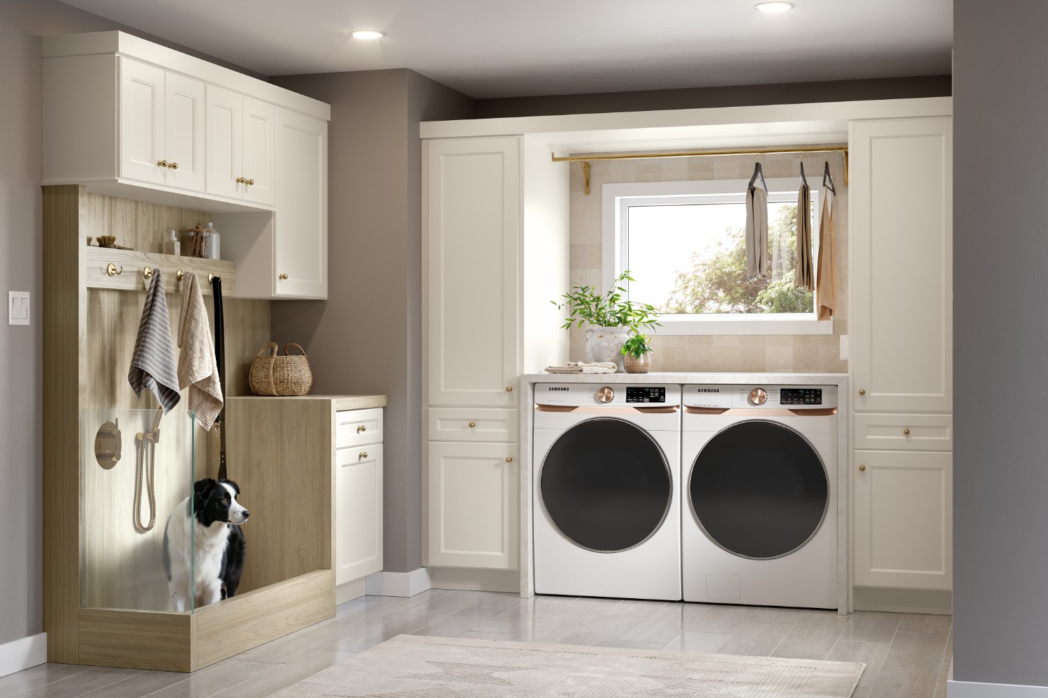 Laundry room featuring kitchen cabinets, a dog wash station, and front-load washer and dryer.