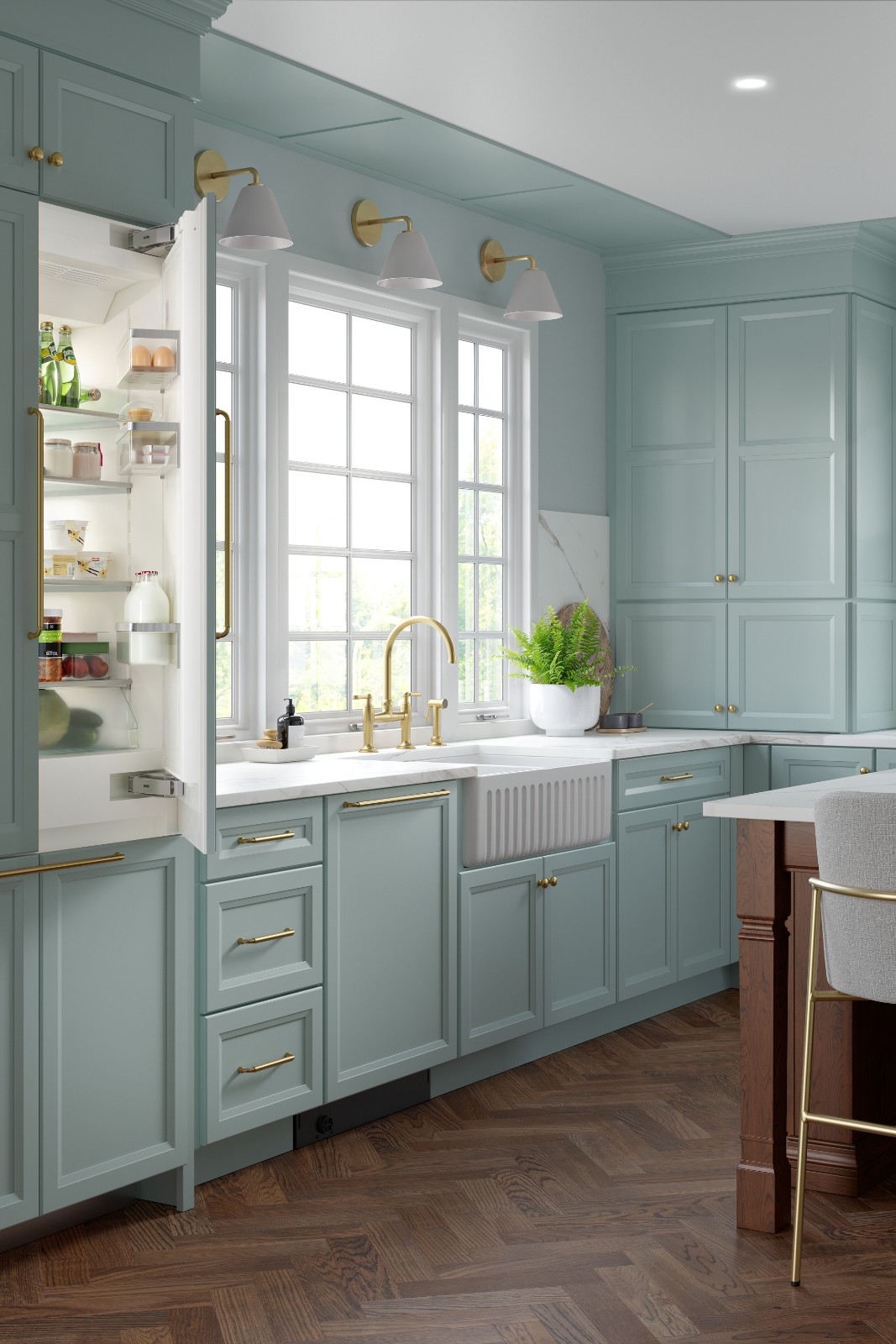 Kitchen with green kitchen cabinets, gold hardware, an open refrigerator, and a farmhouse sink.