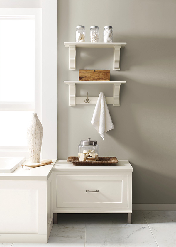 Bathroom vanity and wall shelves with glass jars, a wooden box, and a white towel for inspiration.