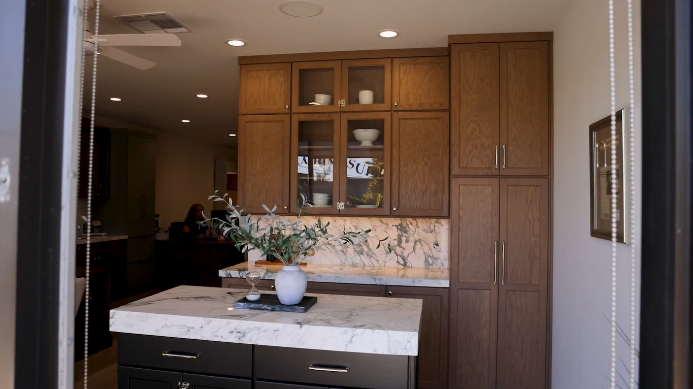 Kitchen with wood cabinets and marble countertops, displayed in a San Leandro, CA showroom.