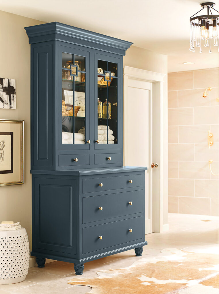 Dark blue cabinet inspiration with glass-front upper storage and three lower drawers.
